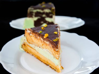 Pistachio cream cake on a white dish