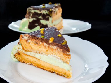 Pistachio cream cake on a white dish