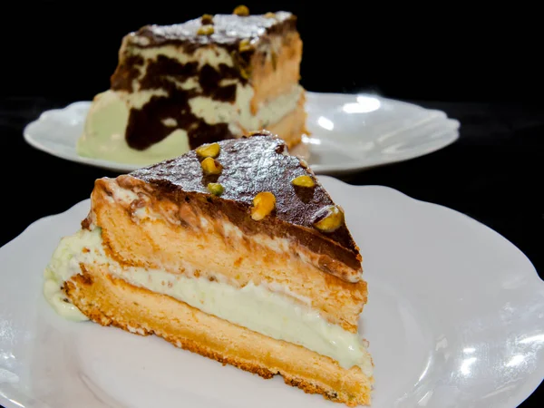 Pistachio cream cake on a white dish