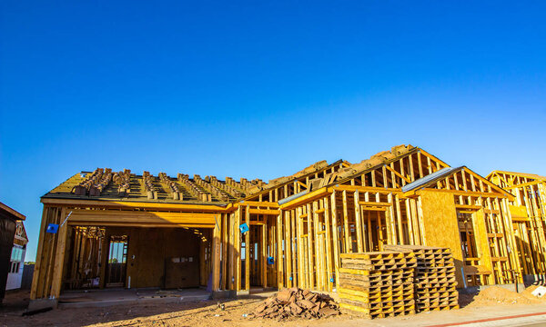 Framing Stage Of New Home Under Construction In Early Evening Light