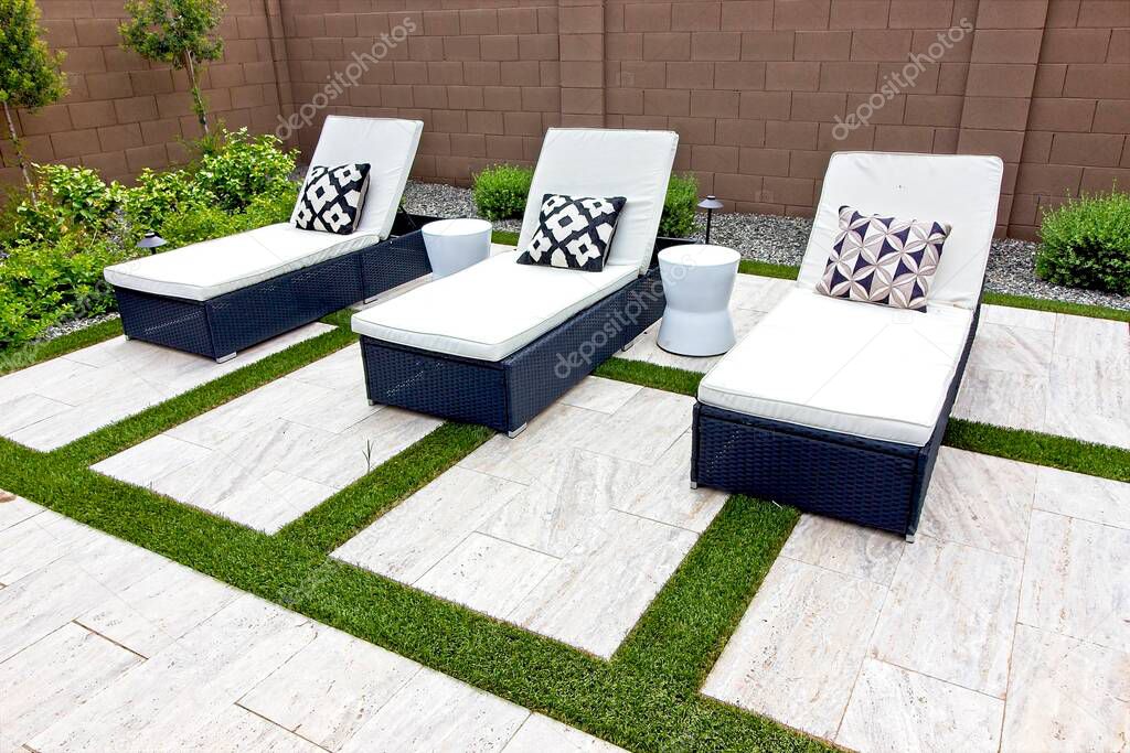 Three White Lounge Chairs On Black Wicker Bases