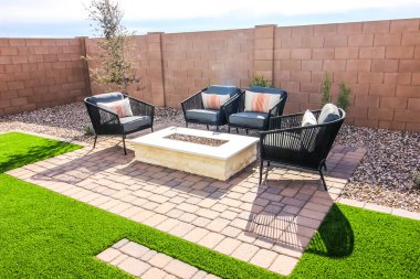 Rear Yard Conversation Area With Four Wicker Chairs On Pavers