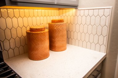 Two Ceramic Containers With Lids On Kitchen Counter Top