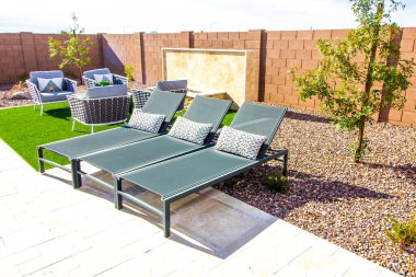 Three Lounge Chairs In Rear Yard Setting