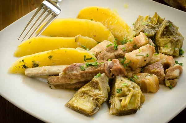 Stew of pork with artichoke and potato, italian cuisine