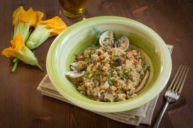 Risotto with seafood and zucchini flowers clipart