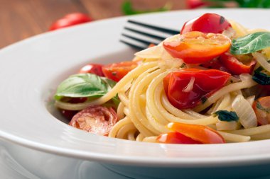 Close up of Delicious spaghetti with tomatoes and basil