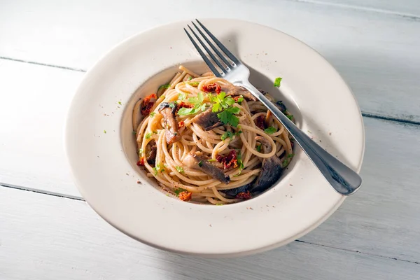 Close up of Delicious spaghetti with mushrooms and dried tomatoes