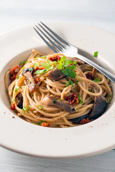 Close up of Delicious spaghetti with mushrooms and dried tomatoes