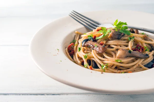 Close up of Delicious spaghetti with mushrooms and dried tomatoes