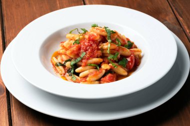 delicious pasta with basil and tomato sauce