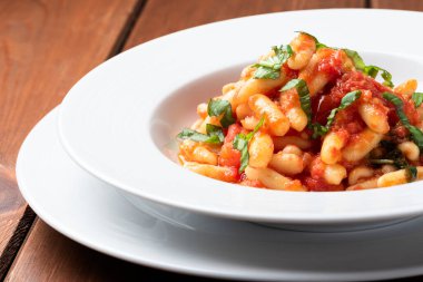 delicious pasta with basil and tomato sauce