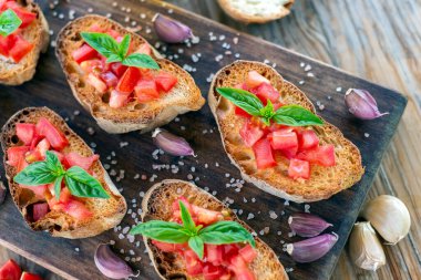 Authentic Italian bruschetta with fresh tomato, extra virgin olive oil, basil and oregano
