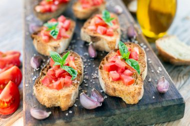 Authentic Italian bruschetta with fresh tomato, extra virgin olive oil, basil and oregano
