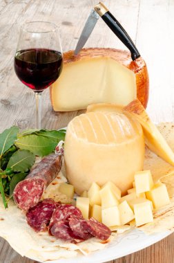 Pork salami, carasau, red wine and pecorino, typical sardinian products, rustic italian food