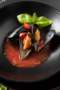 Delicious cozze alla sorrentina, a recipe of mussels with tomato sauce, italian food