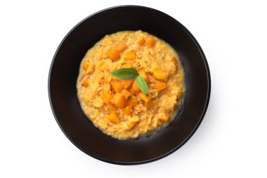 Top view of a delicious pumpkin risotto plate, isolated on white background, italian food