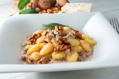 Gorgonzola, ceviz ve İtalyan yemeğiyle bir tabak patates gnocchi.