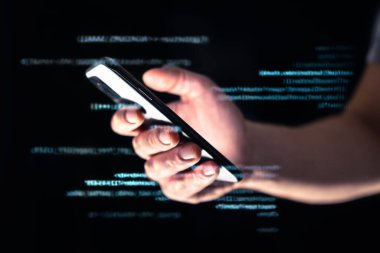 Telefon dolandırıcılığı, hackleme ya da dolandırıcılık. Akıllı telefonla veri hackerı çevrimiçi. Darknet 'te ya da internette telefon dolandırıcısı. Teknoloji ve internet ile siber güvenlik tehdidi. Dijital kod teknolojisi. Cep telefonu kullanılıyor.