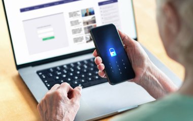 Senior and phone with lock password to protect data in online bank website. Old woman with smartphone. Cyber security and personal information safety and privacy from hacker fraud. Elder person.