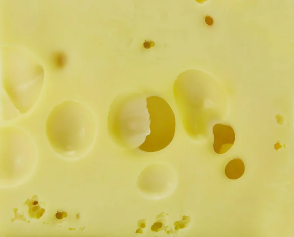 Een Stuk Kaas Met Grote Gaten Textuur Van Het Oppervlak — Stockfoto