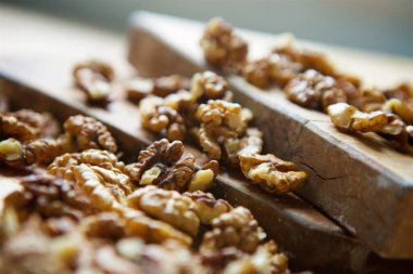 Walnuts peeled without shells lie on a wooden table on a cutting Board.