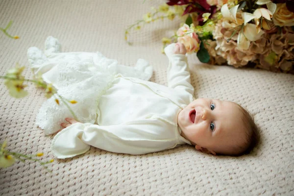 Little Newborn Baby Girl Lying White Clothes Beige Bedspread Flowers — 图库照片