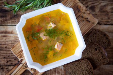 Restorandaki masada lezzetli bir alabalık kulağı var. Bir somun siyah ekmek, pita ekmeği ve yeşil dereotunun arka planında. Yemek ve restoran menüsü.