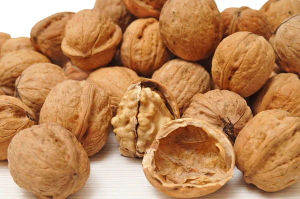 Walnuts and a cracked walnut — Stock Photo, Image