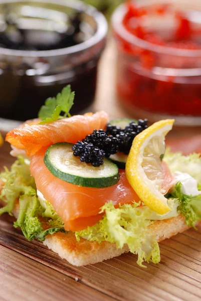 Canapes with salmon and caviar — Stock Photo, Image
