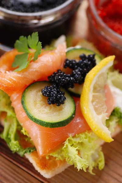 Canapes with salmon and caviar — Stock Photo, Image