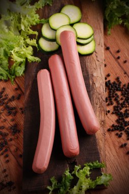 uncooked frankfurters with fresh vegetables clipart
