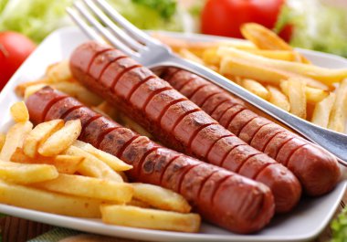 Roasted frankfurters with French fries clipart