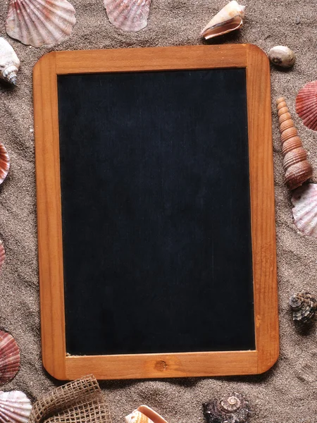 Small blank blackboard on the sand — Stock Photo, Image