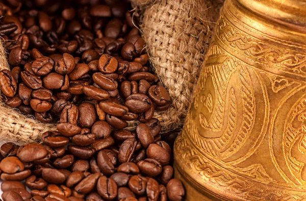 Arabic copper turks and scattered coffee grains — Stock Photo, Image