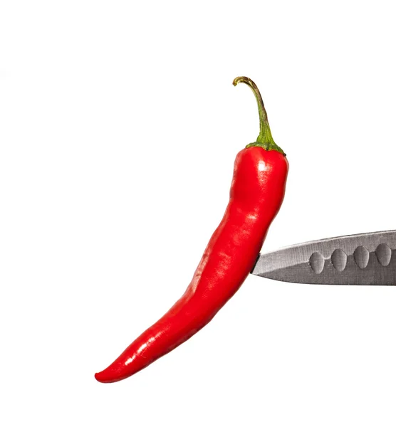 Red pepper on a knife edge — Stock Photo, Image