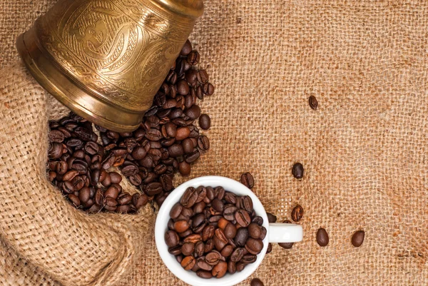 Turcos de cobre árabe, taza y granos de café dispersos — Foto de Stock