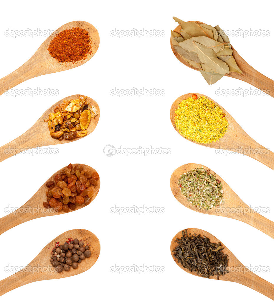 wooden spoons with seasonings on a white background