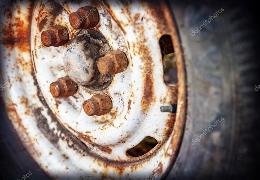 old car wheel with rusty bolts