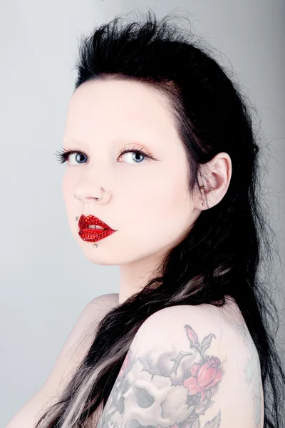 Beautiful girl with red rubies on the lips — Stock Photo, Image