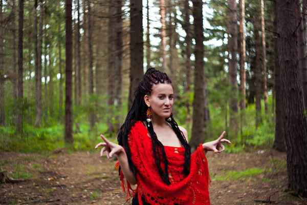 Scared girl with dreadlocks on the background of the forest — Stock Photo, Image