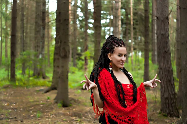 Mysterious girl with dreadlocks wrapped in a red knitted scarf i — Stock Photo, Image