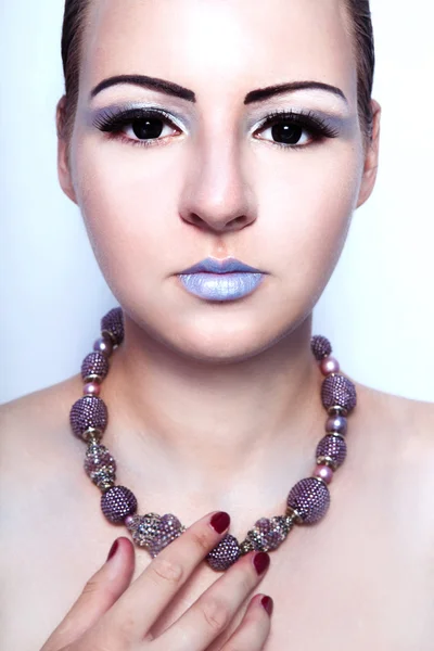 Beautiful alien woman with beads on the neck and black eyes — Stock Photo, Image