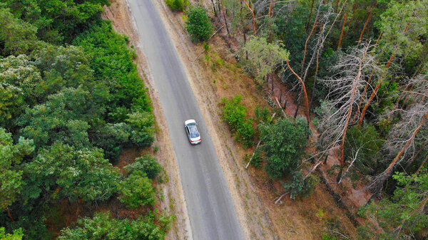 Aerial. Car driving at the asphalt country road. View above from drone. 