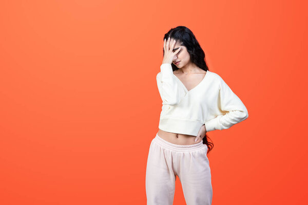 Facepalm concept. Upset asian-indian ethnicity woman covers her face with her hand. Studio shot.