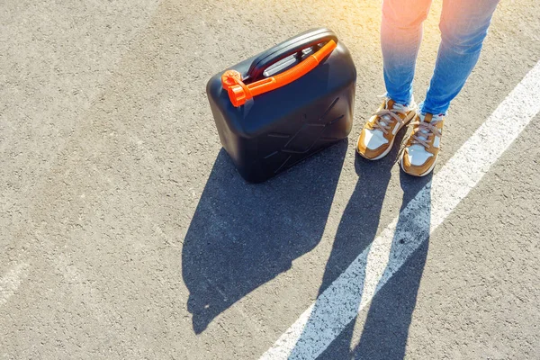 A fuel cans with petrol or diesel standing on the ground. Fuel reserve in jerrycans. Lack of petrol or diesel at gas stations concept.