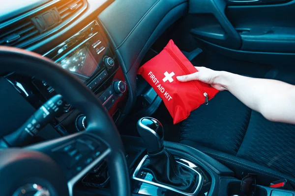 Female Hand Taking Red First Aid Kit Car Glove Box — Foto de Stock