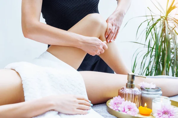 Massage and spa. Leg massaging. Unrecognizable women. Luxury spa, body care, healthy lifestyle.