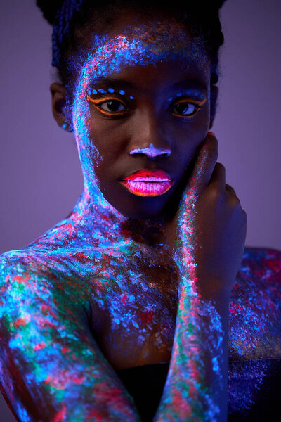 Fashion model lady in neon light, portrait of charming model with fluorescent make-up
