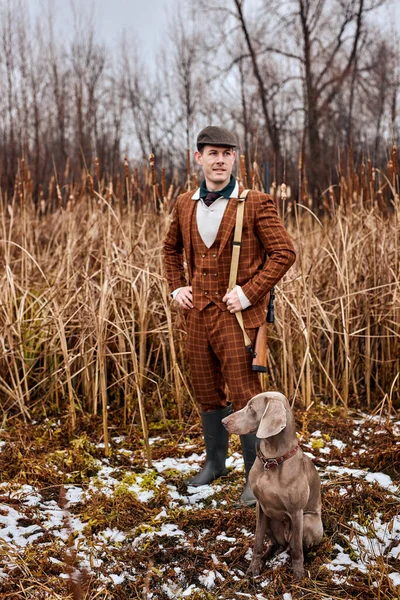 Jägare med hund i skogen. En man med hagelgevär. Jägarmannen. Jaktperiod, höstsäsong. — Stockfoto